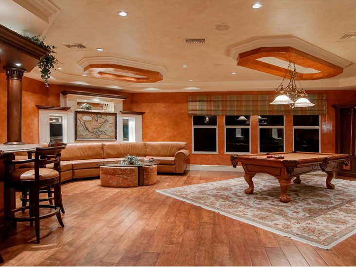 Large game room with warm laminate flooring