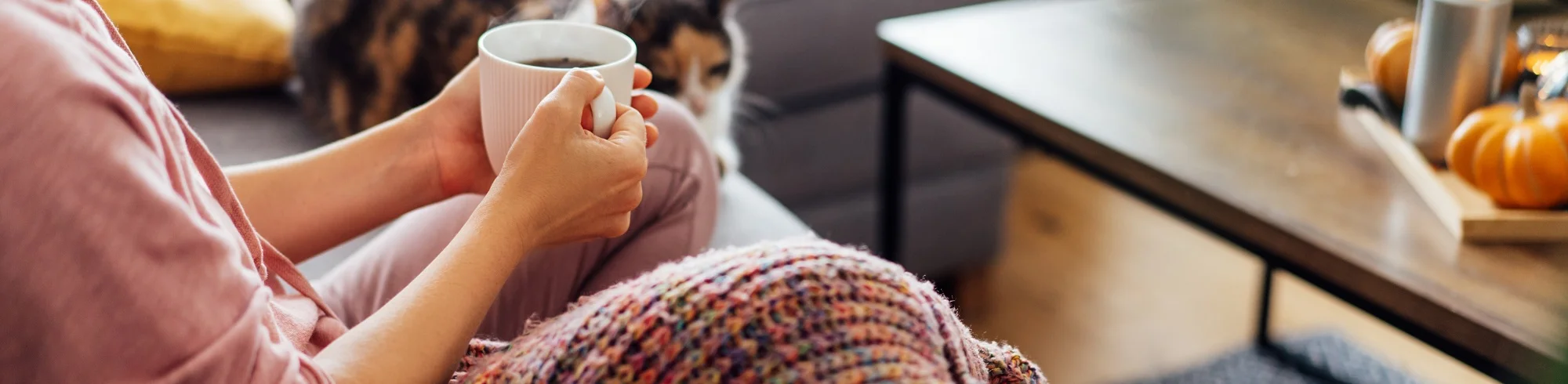 Woman sitting enjoying a cup of coffee